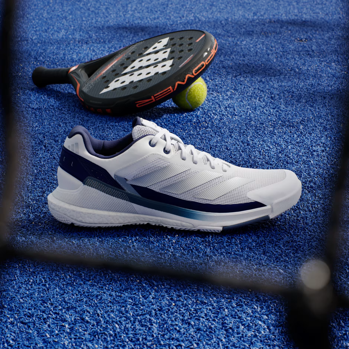 Adidas Crazyquick Boost Cloud White padel shoe, side view on court with a padel racket