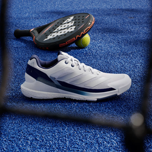 Adidas Crazyquick Boost Cloud White padel shoe, side view on court with a padel racket