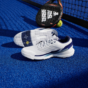 Adidas Crazyquick Boost padel shoes, pair on court showing the upper and three stripes