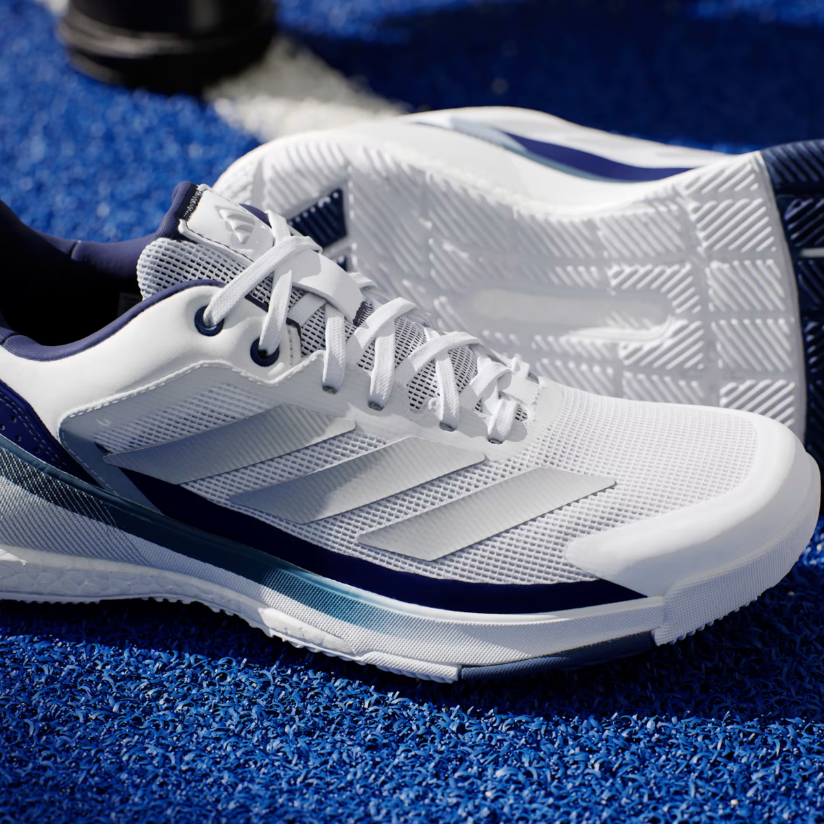 Adidas Crazyquick Boost padel shoe, close-up of the Dark Blue heel and three stripes