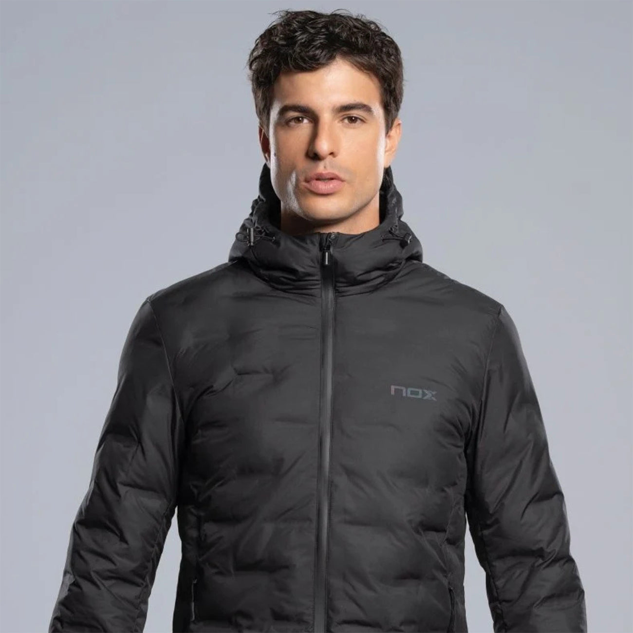 Nox Team quilted jacket in black, front view worn by a male model